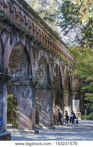 KYOTO JAPAN -NOV 20 2015: The tourists at the Suirokaku brick ancient aqueduct in Kyoto. This aqueduct was constructed in 1889 to carry water and goods between Kyoto and Lake Biwa