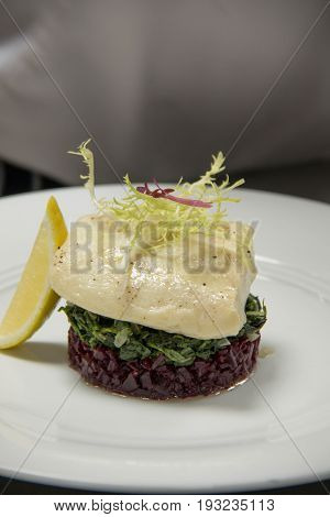 Tasty grilled fish steak onl vegetables and lemons