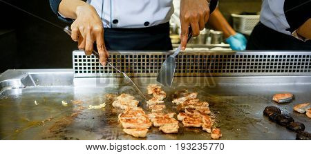 Hand Of Chef Cooking Chicken Steak