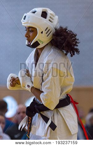 BERLIN - MARCH 18 2017: Girl-fighter in a protective helmet close-up. European championship Kyokushin World Union (KWU) for Children and Youth.
