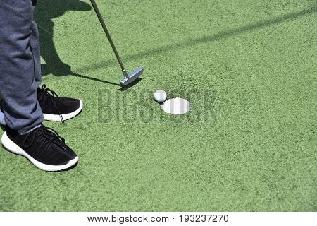 Boy Playing In Minigolf