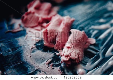 Ice cream roll fried in the fridge freezer pan on the street in Thailand fresh cooking made from fresh strawberries milk blueberries. Concept of tourist delicacy.