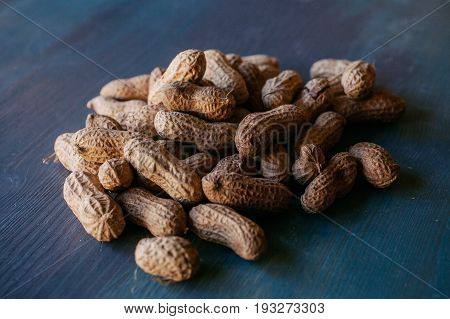 Peanut in shell texture and background. Peanuts texture. Shelled Peanuts. Healthy food. Close up view of shelled peanuts in wooden background. Abstract background and texture for designers.