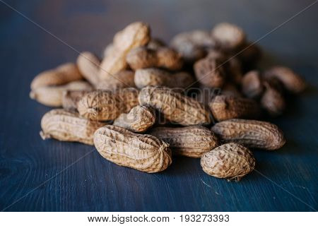 Peanut in shell texture and background. Peanuts texture. Shelled Peanuts. Healthy food. Close up view of shelled peanuts in wooden background. Abstract background and texture for designers.