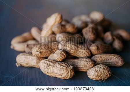 Peanut in shell texture and background. Peanuts texture. Shelled Peanuts. Healthy food. Close up view of shelled peanuts in wooden background. Abstract background and texture for designers.