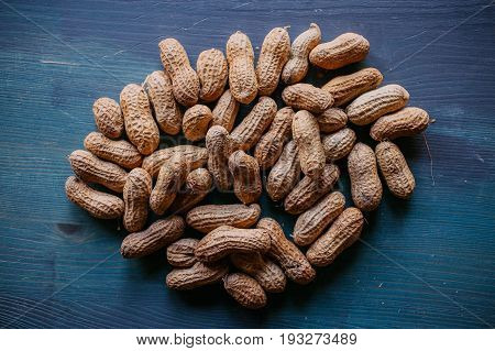 Peanut in shell texture and background. Peanuts texture. Shelled Peanuts. Healthy food. Close up view of shelled peanuts in wooden background. Abstract background and texture for designers.