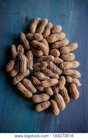 Peanut in shell texture and background. Peanuts texture. Shelled Peanuts. Healthy food. Close up view of shelled peanuts in wooden background. Abstract background and texture for designers.