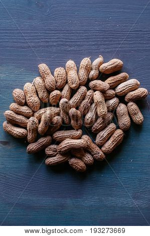 Peanut in shell texture and background. Peanuts texture. Shelled Peanuts. Healthy food. Close up view of shelled peanuts in wooden background. Abstract background and texture for designers.