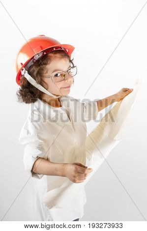Young curly superintendent holding a drawing and looking at the camera. Gray background.