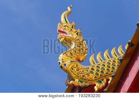 Beautiful Golden Thai Temple Architecture: Naga Wood Carved At Chapel Roof Of Wat Phrathat Hariphunc