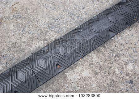 Old Black Rubber Speed Bumper Humps on the road.