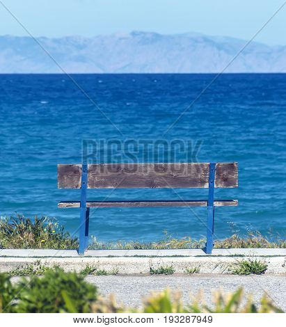 Old wooden bench overlooking the sea and mountains