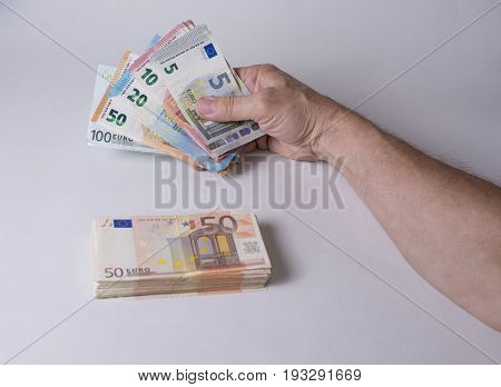 Euro banknotes in the hand ready to spend or offer