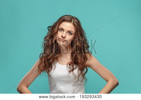 Portrait of an angry woman looking at camera isolated on a blue background