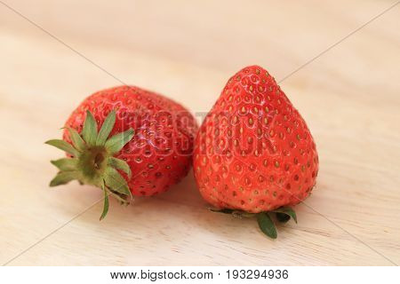 Close up of fresh strawberries on wooden background.