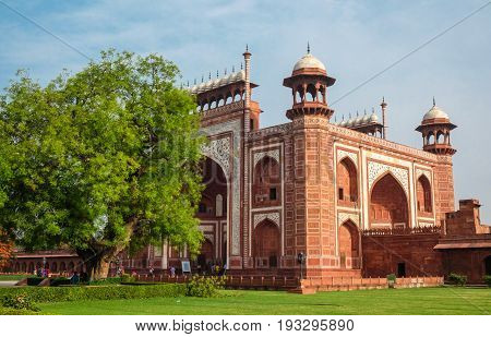 Taj Mahal's western gate at sunrise Agra India