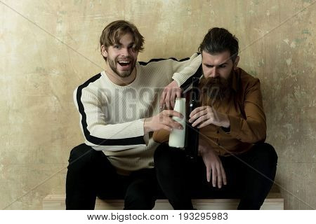 Man Laughing With Milk And Serious Model With Wine