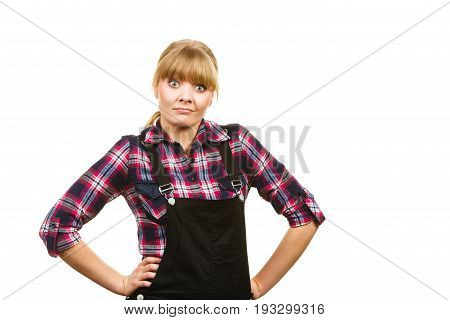 Gardening fahion concept. Attractive woman in pink check shirt and dungarees shocked surprised face expression. Isolated background