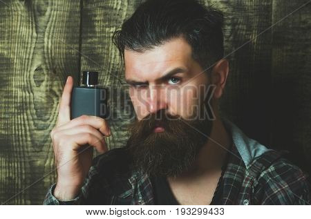 Hipster Posing With Black Perfume Or Cologne Bottle