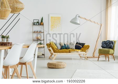 Round wicker footrest lying on the floor in living room