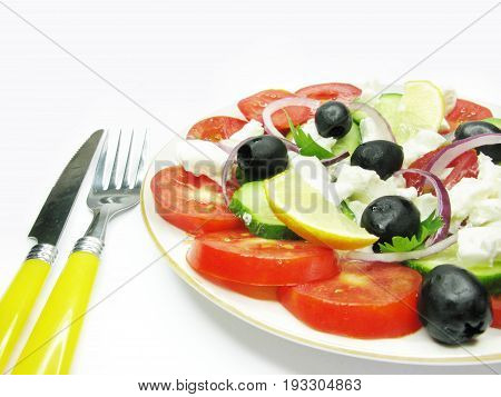 greek salad with fork and knife isolated
