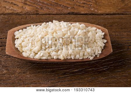 White Grated Corn Kernels In Wooden Bowl. Canjica / Mungunza
