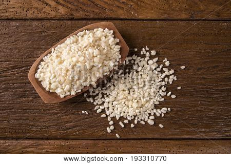 White Grated Corn Kernels In Wooden Bowl. Canjica / Mungunza