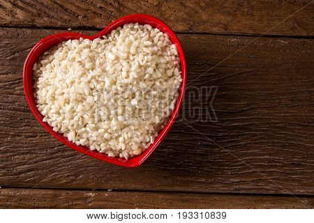 White Grated Corn Kernels In Wooden Bowl. Canjica / Mungunza