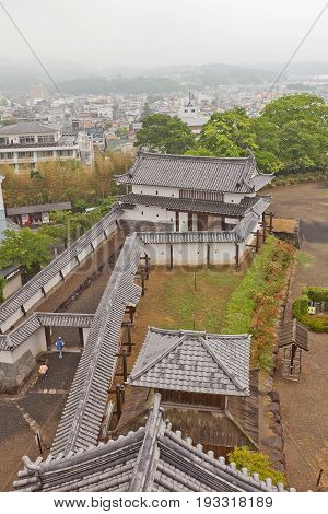 SHIROISHI JAPAN - MAY 25 2017: View of reconstructed Main gate and protective walls of Shiroishi Castle Japan from main keep. Castle was founded in 1591 by Gamo Ujisato and dismantled in 1875