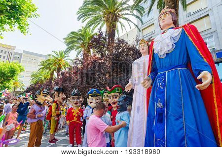 Badajoz, Spain - june 24, 2017: Disguised figures known as giants and big heads,  roughly gigantes y cabezudos parade for the children in the city of Badajoz