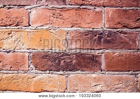 Brick red wall hand-laying. Vintage solid walls manual clutch of natural bricks. Construction of buildings and fortifications.