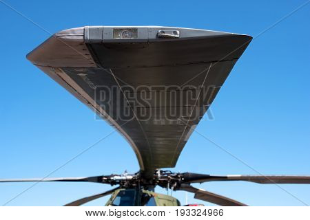 Details of the rotor and part of the body of modern military helicopters closeup. At the tip of the blade is a warning light.