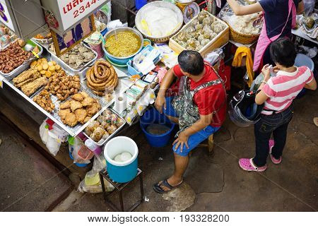 CHIANG MAI THAILAND - AUGUST 24: Man sells food at the market on August 24 2016 in Chiang Mai Thailand.