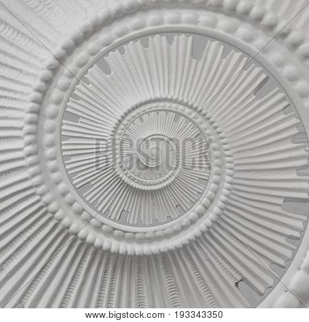 White stucco moulding plasterwork spiral abstract fractal pattern background. 
