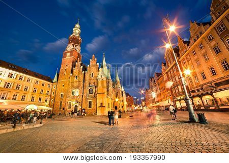 Colorful Evening Scene On Wroclaw Market Square With Town Hall.