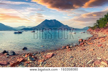 Picturesque Mediterranean seascape in Turkey. Colorful spring sunset in Adrasan bay with view of Moses Mountain. Artistic style post processed photo.