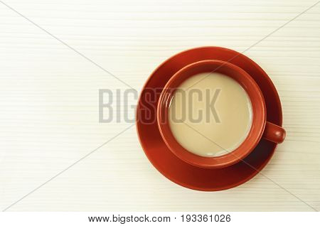 ceramic cup with fresh coffee on wooden background