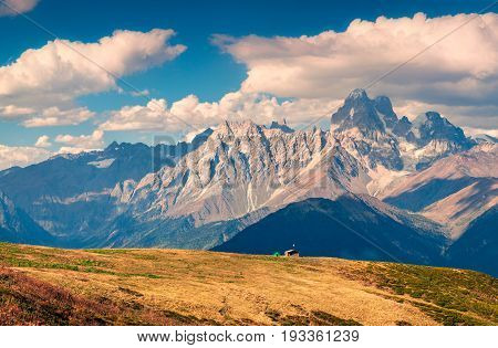 Colorful Autumn Landscape With Shepherd House And Green Tourist Tent.
