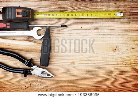 Close up tools on a wooden background