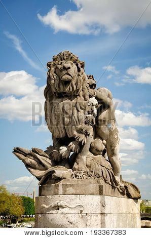 Paris France - April 18 2013:View of sculpture Lion steered by a child (Lion conduit par un enfant) at Alexander III bridge. Copy space in sky.