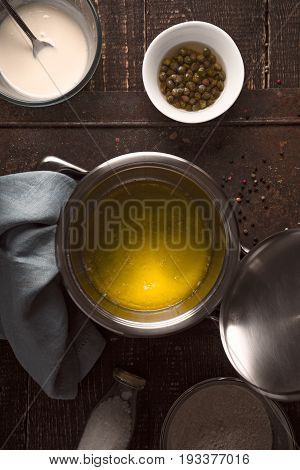 Broth , flour , butter , capers and black pepper on the wooden table top view