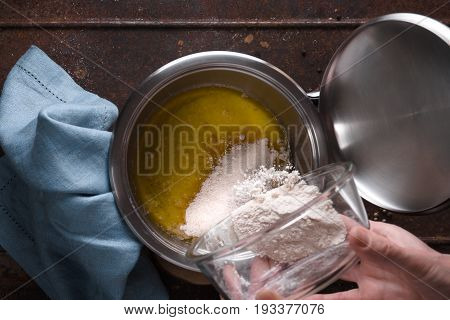 Preparation of veloute sauce on the wooden table  top view horizontal