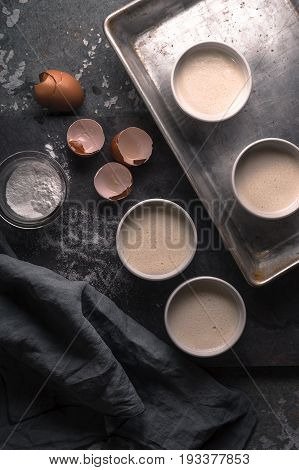 Creme brulee  without the caramelized crust in the ramekins on the stone background top view vertical