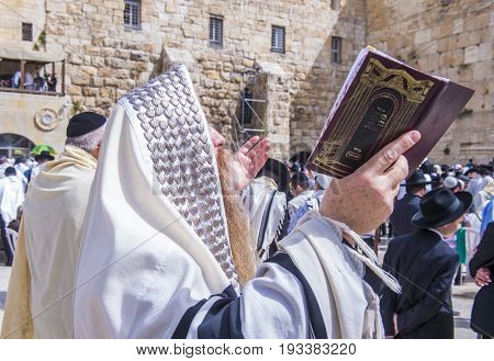 JERUSALEM - APRIL 13 : Orthodox jewish men prays in The western wall during Passover on April 13 2017 The Western wall is important Jewish religious site located in the Old City of Jerusalem
