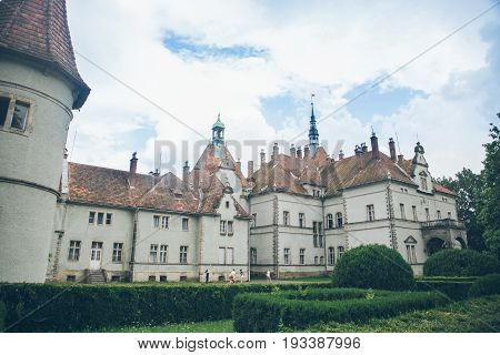 Old palace in prak with white clouds on background