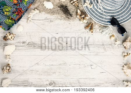 Sand and shells and hat on the wooden floor summer concept travel Seychely beach Florida Hawai swimm in Bali summer pradise