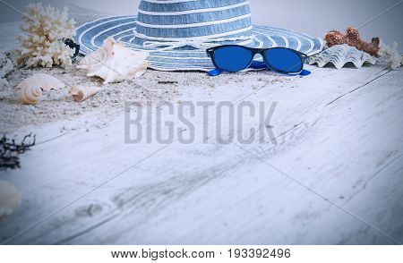 Sand and shells and hat on the wooden floor summer concept travel Seychely beach Florida Hawai swimm in Bali summer pradise