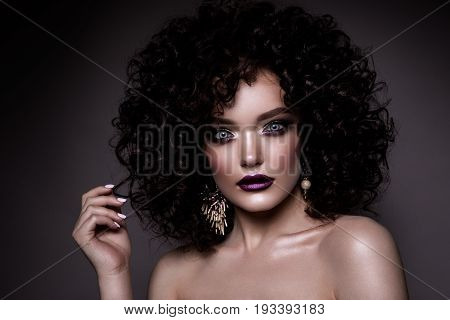 Beauty young woman with curly small and long hair. Permed hair. Glamour lady, Beautiful Girl on gray background. Portrait. Wavy Hair, perfect make up. Closed eyes.