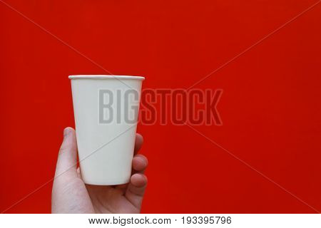 White paper glass on a red background.