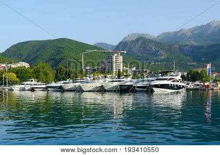 BUDVA MONTENEGRO - SEPTEMBER 17 2015: Pleasure boats and yachts at pier on promenade of popular resort Budva Montenegro